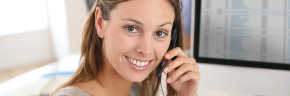 Beautiful smiling teleoperator with headset on